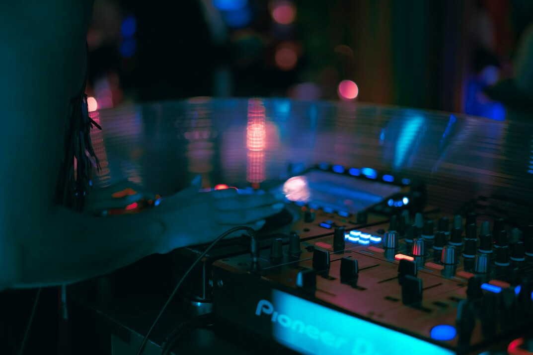 Close-up of a professional audio mixing console with faders